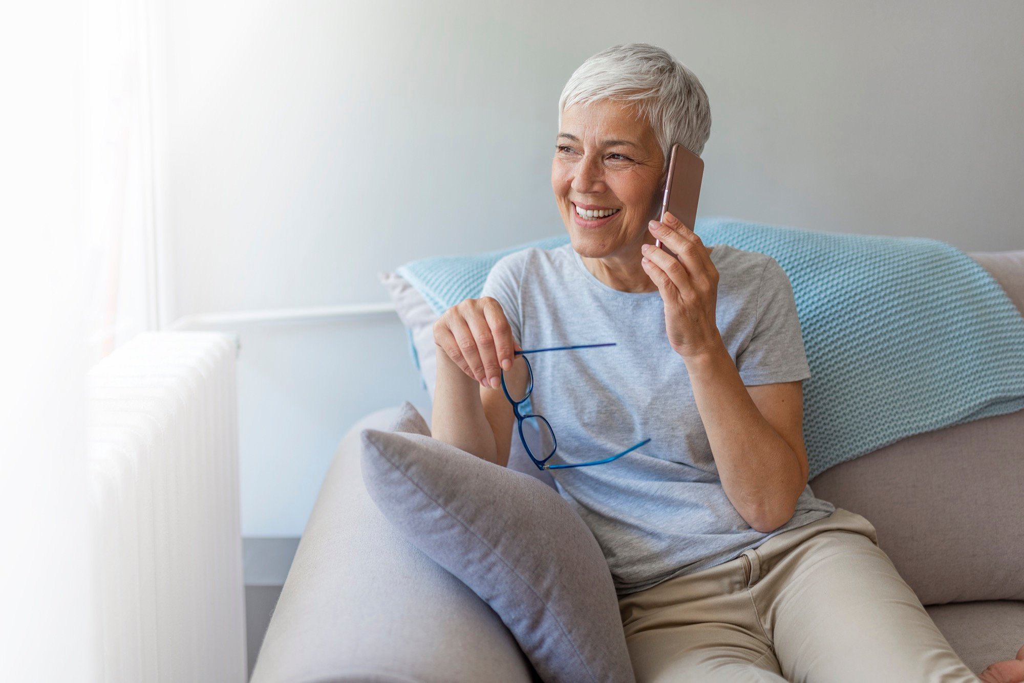 SYC _ Healthcare Consumer on Phone Female with glasses on phone- sofa