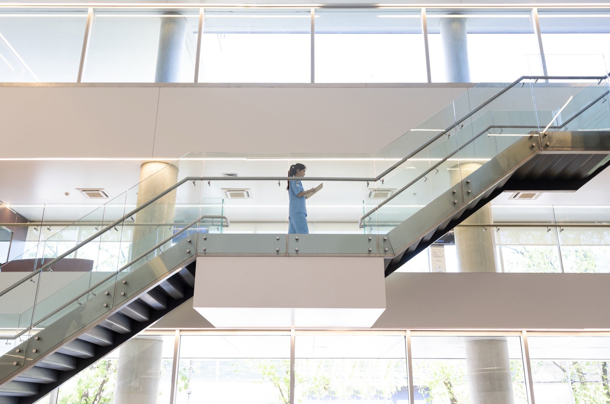 Female doctor on stairs- Blue
