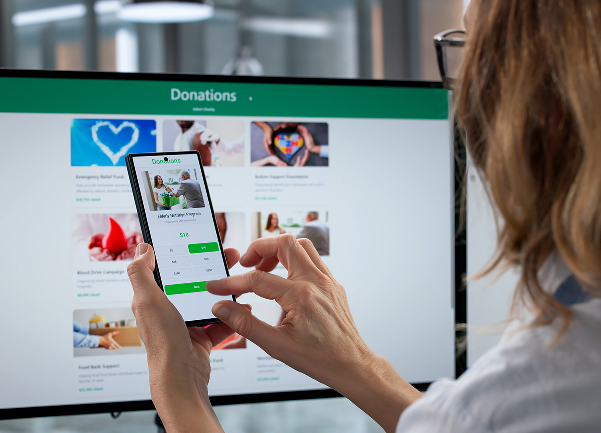 Woman using online charity app to donate money securely